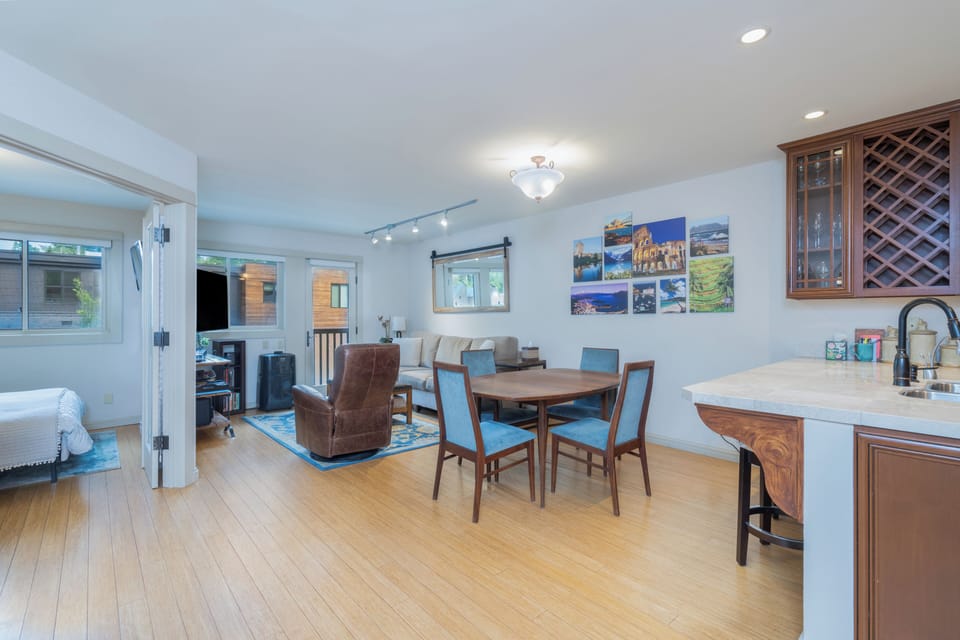 Bright, open living space with warm wood floors, dining for four, and a cozy bedroom just steps away—perfect for unwinding after your adventures.