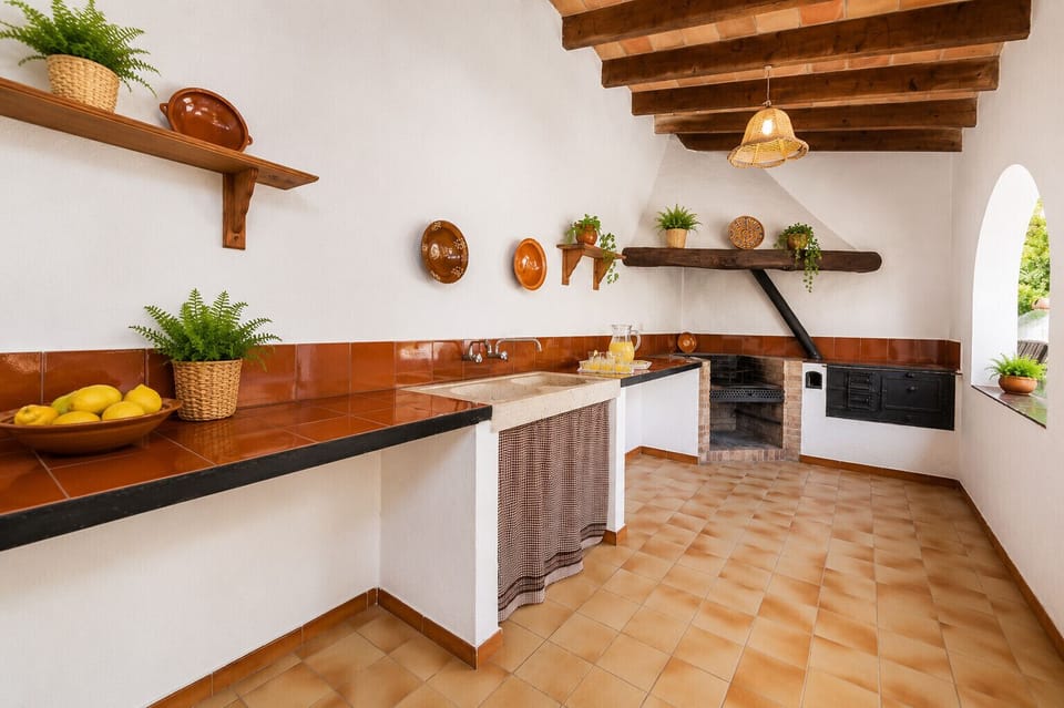Villa Gorgs Petit in Pollensa with Mediterranean outdoor kitchen, traditional barbecue and spacious outdoor areas in Mallorca.