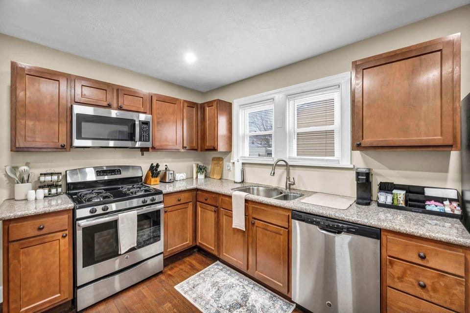 Well-equipped kitchen w/ stainless steel appliances & warm wood cabinetry.
