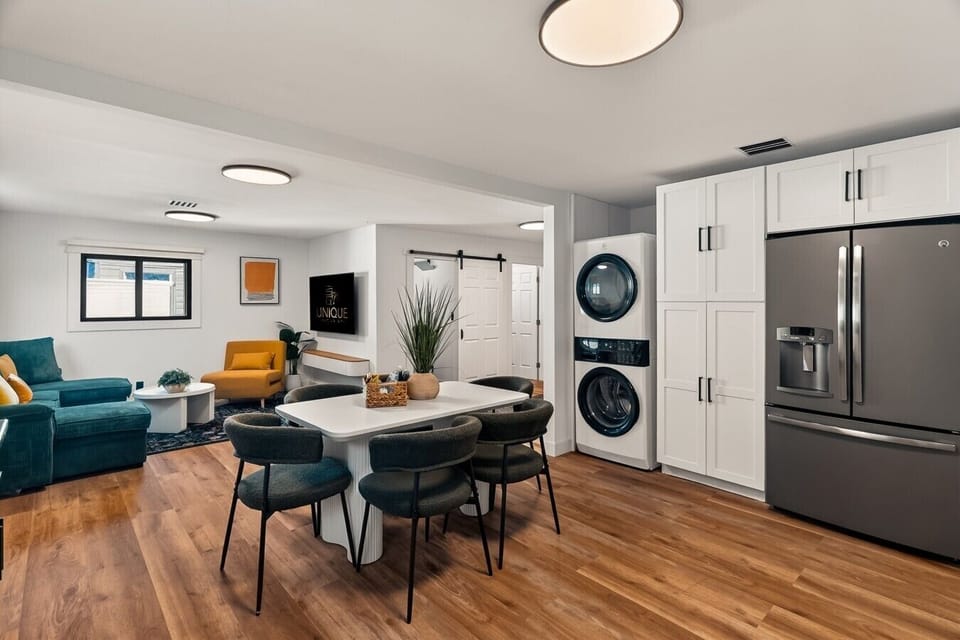 Spacious Open-Concept Kitchen & Dining Area with Seating for Six, Fully Equipped for Cooking, Plus Convenient In-Unit Washer & Dryer for Longer Stays.