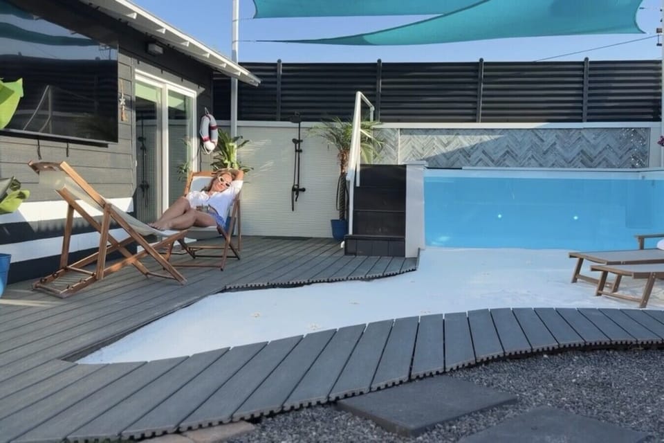 Slow down and recharge beside your private heated glass pool and white-sand wellness retreat.