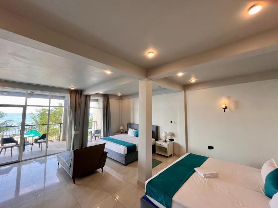Deluxe Double Room, Balcony, Ocean View | In-room safe, laptop workspace, blackout drapes, iron/ironing board