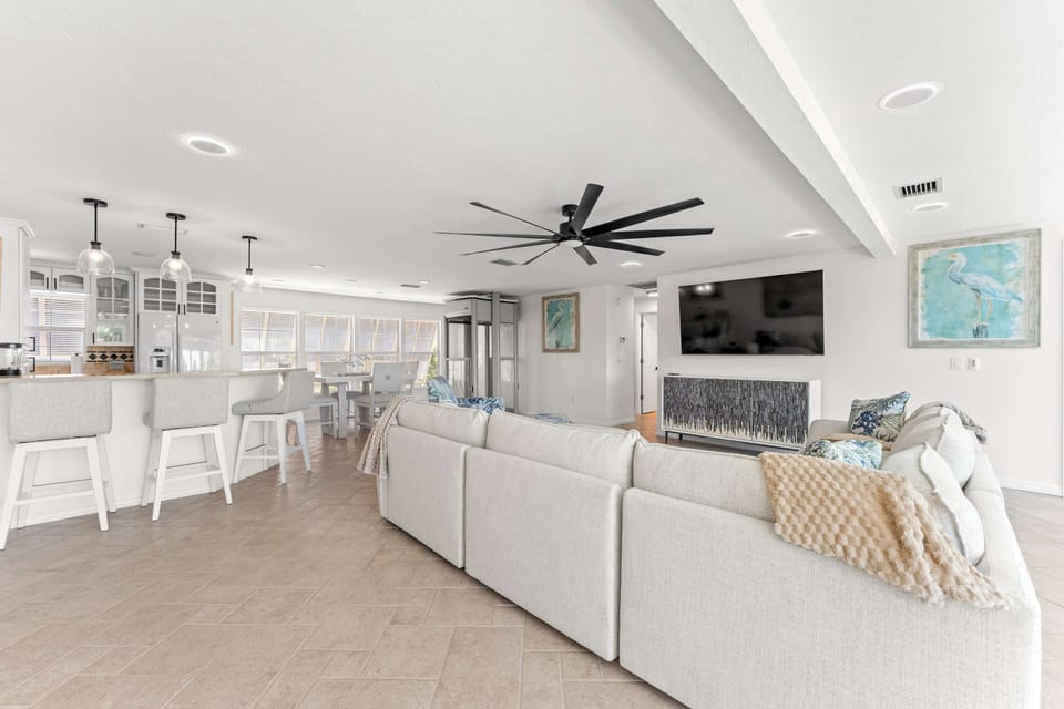 Modern coastal getaway with an open-concept design. Enjoy spacious living, cozy seating, and a bright kitchen perfect for gathering with family and friends after a fun day on the water or at the beach!