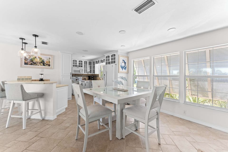 Bright and airy dining space. Enjoy meals together in this beautiful open-concept area filled with natural light, coastal charm, and the perfect atmosphere for unforgettable family dinners and vacation moments!