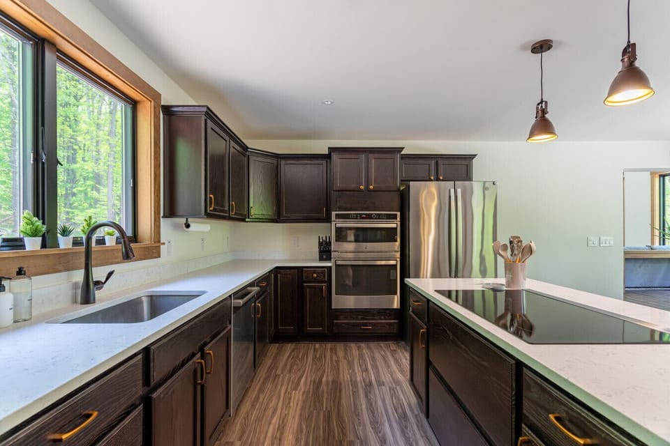 Fully equipped kitchen featuring new stainless steel appliances for easy, everyday cooking