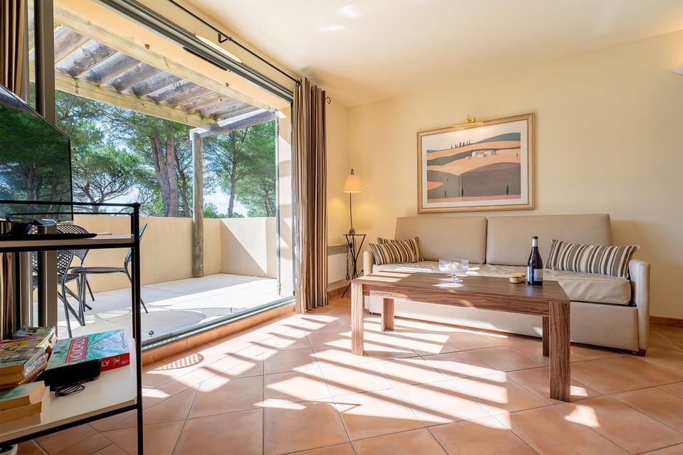 Sun-dappled interiors open directly onto your private terrace — indoor-outdoor living at its best.