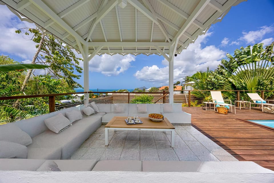 Create unforgettable memories at Villa Bel Peyi: a spacious terrace and a carbet with panoramic views of the Caribbean Sea in Sainte-Luce.