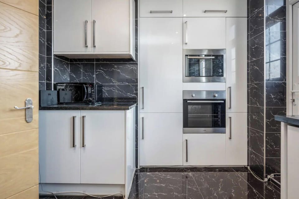 Kitchen appliance tower with integrated oven and built-in microwave — fully equipped for cooking full meals throughout your stay.