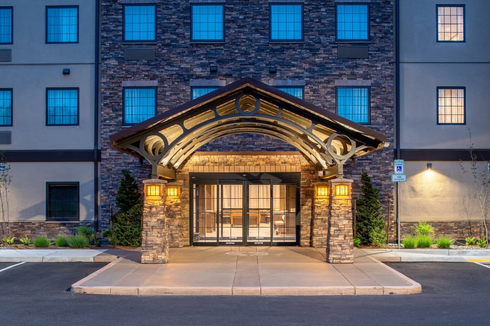 Hotel entrance with decorative arch and stone facade.