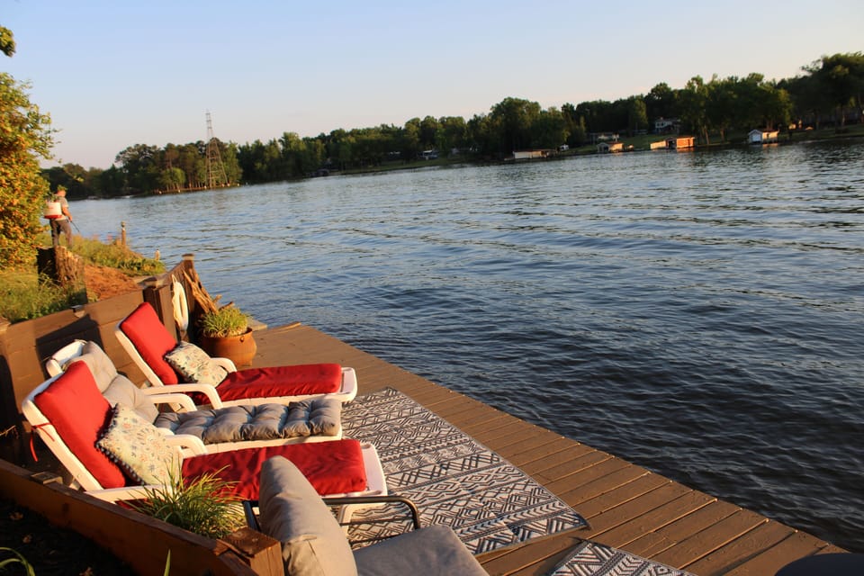     Lakefront dock with lounge chairs and relaxing waterfront views