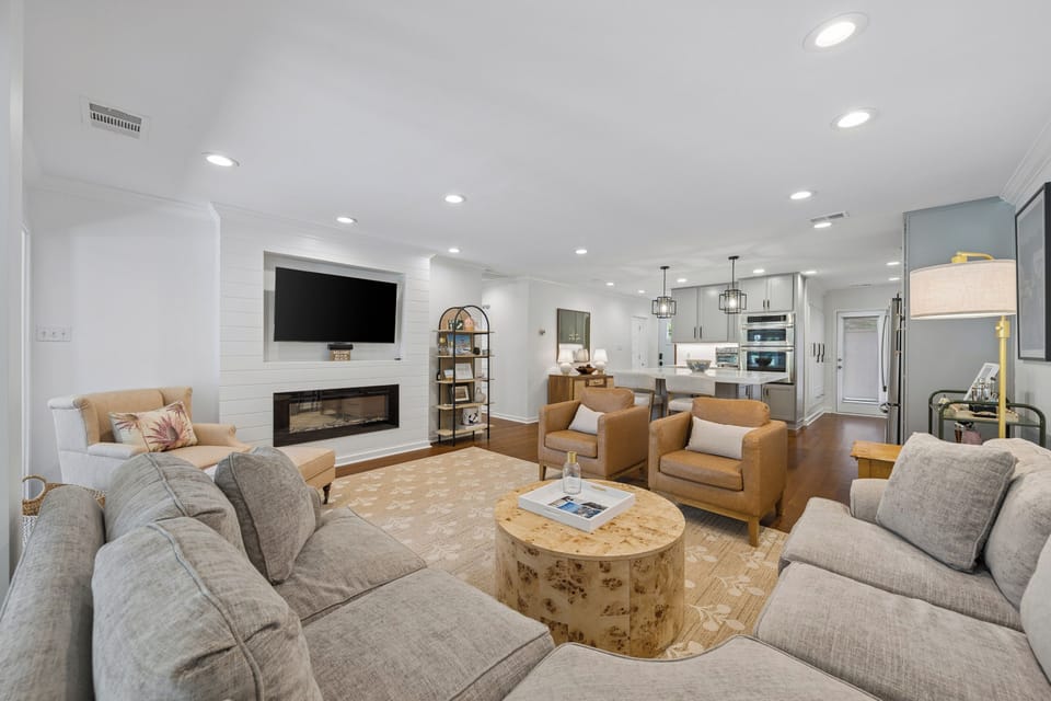 Spacious living area featuring plenty of seating and a large flatscreen tv.