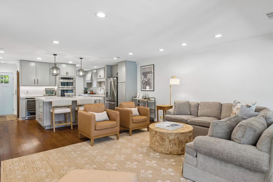 Spacious living area featuring plenty of seating and a large flatscreen tv.
