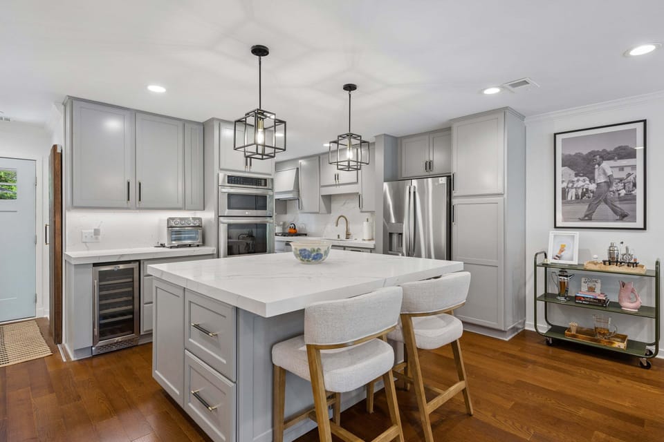 Fully stocked kitchen featuring all stainless steel appliances. This kitchen also features 2 barstool for extra seating and a wine cooler.