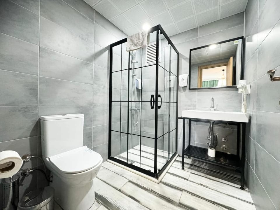 Shower, hair dryer, slippers, towels