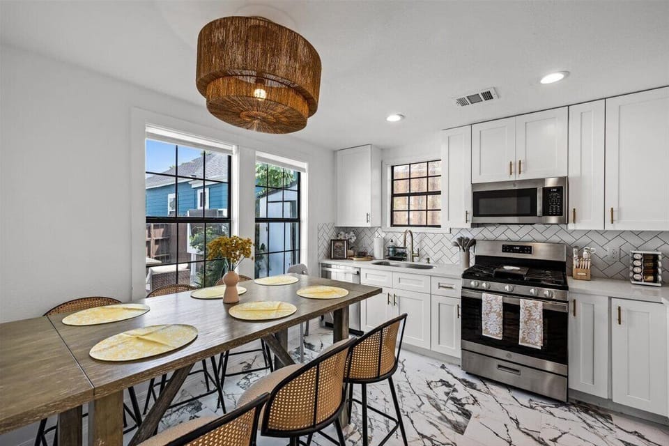 An open kitchen that flows seamlessly into the living room, creating a warm and connected space for gathering. Conveniently located near the backyard entrance for easy indoor-outdoor living and effortless entertaining.