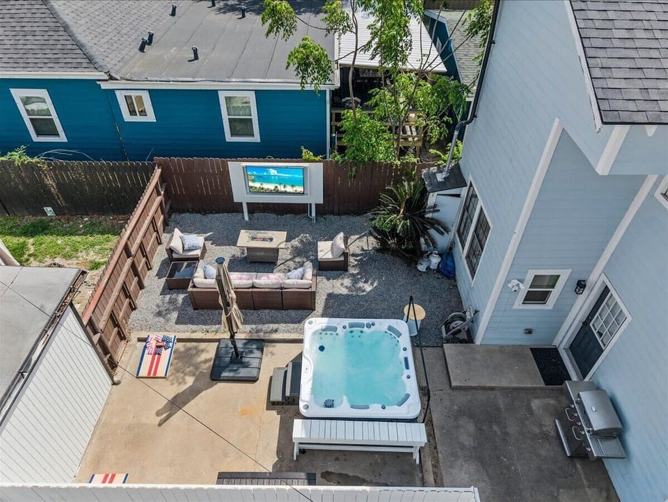 Take it all in from above, where sun-soaked lounge areas, a bubbling spa, and inviting outdoor seating come together for the perfect day or night. Whether you’re unwinding or entertaining, this private backyard is designed for effortless enjoyment.