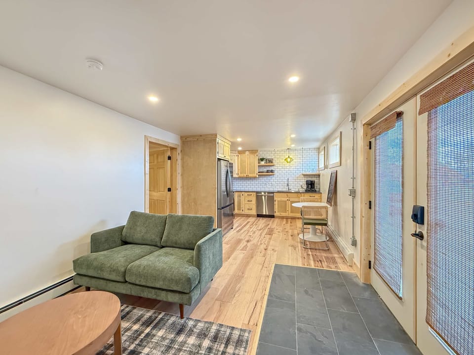【Living + Kitchen】 Open layout, gas range visible — the whole front of the unit