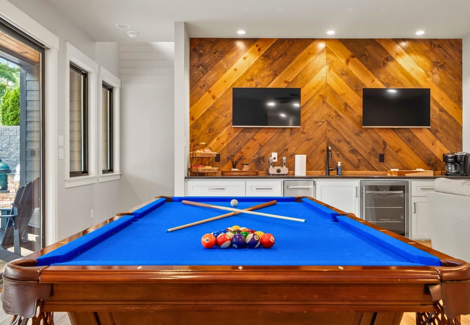 Rustic wood accents and dual TVs create a fun entertainment space that's ready for game nights, karaoke, or catching the big game.
