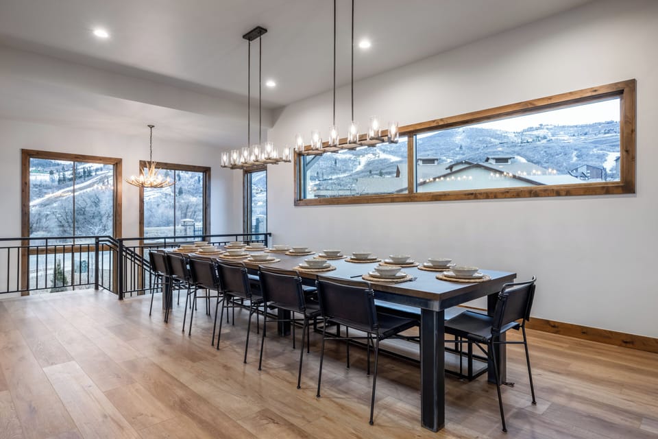Long dining table · floor-to-ceiling views