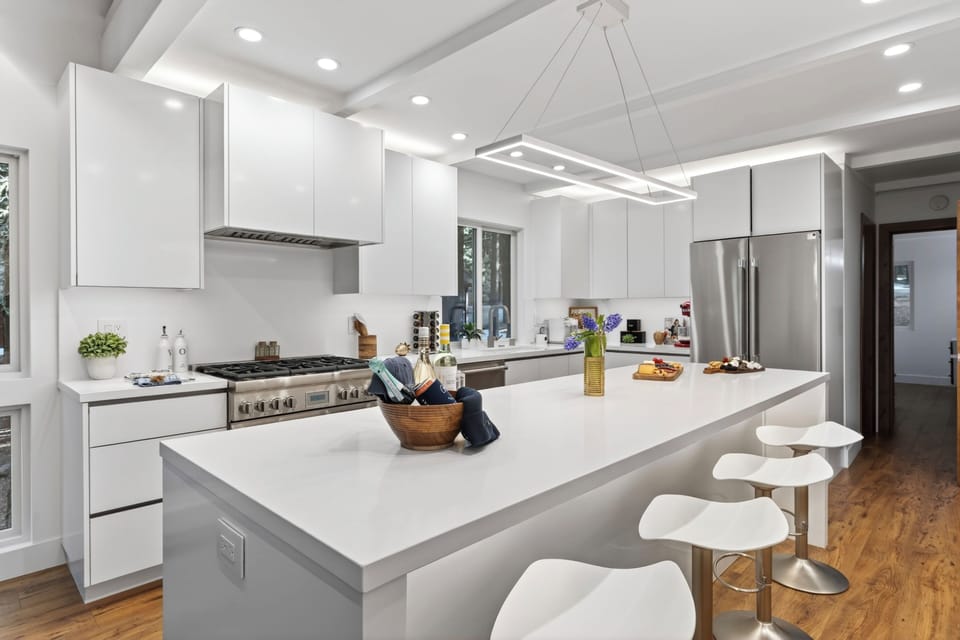 Crisp white quartz countertops offer ample prep space for culinary enthusiasts.