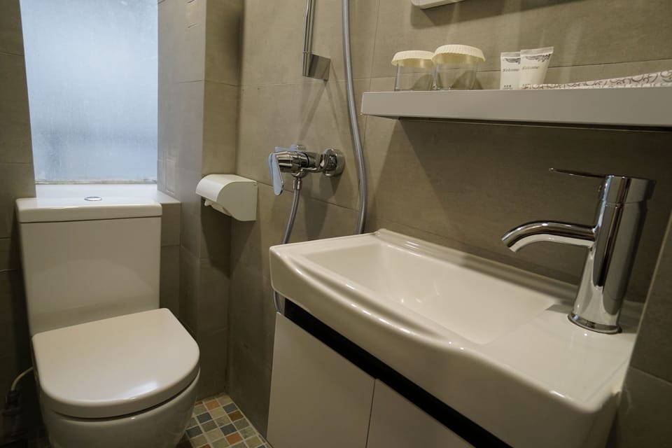 Shower, hair dryer, slippers, towels