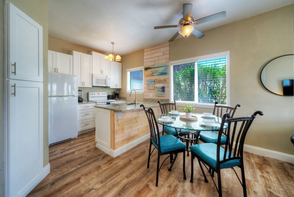 Enjoy casual meals in a bright dining nook beside the beach-inspired kitchen.