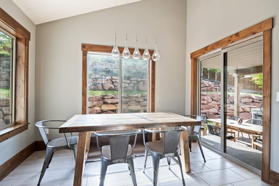 Bright dining area with seating for guests and sliding glass doors leading to the outdoor patio for easy indoor-outdoor living.