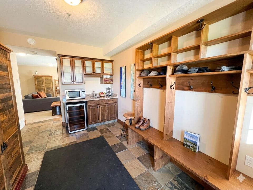 Dedicated storage and drying for your activity gear. Rear door leading to the lower-level private hot tub.