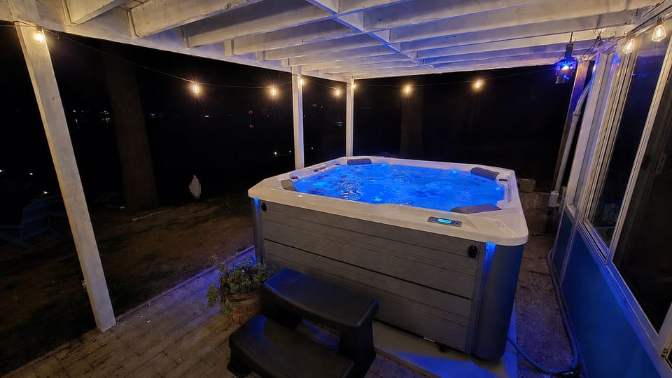 EXTERIOR:  The incredible new 6-person hot tub, with a great view of Bass Lake from the hot tub!