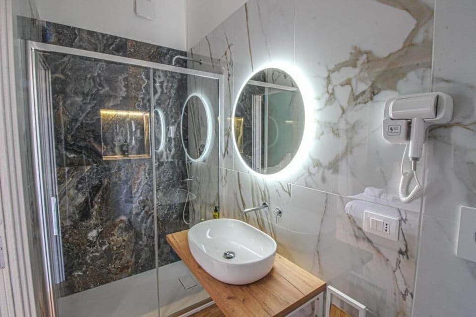Luxury Triple Room, Balcony | Bathroom | Shower, rainfall showerhead, free toiletries, hair dryer