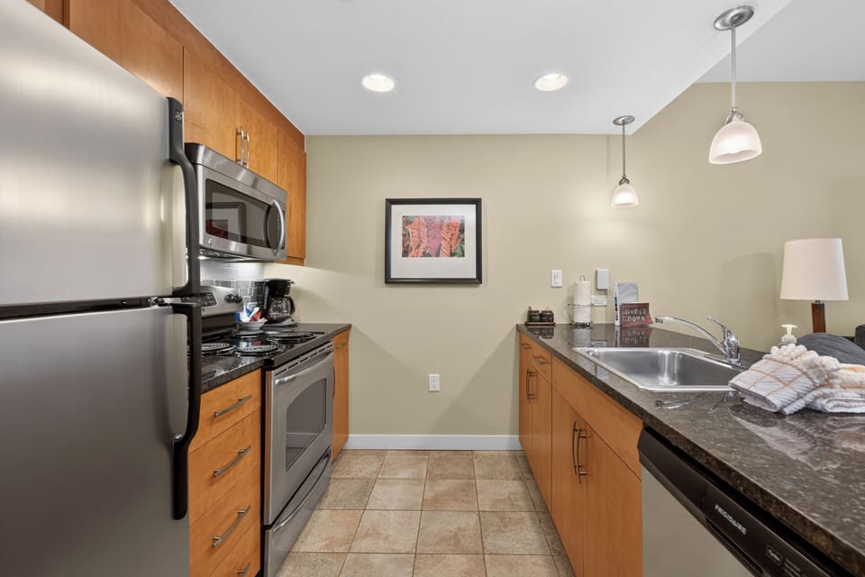 Your fully equipped kitchen awaits with stainless steel appliances, granite countertops, and everything you need to prepare your favorite meals in comfort and style.
