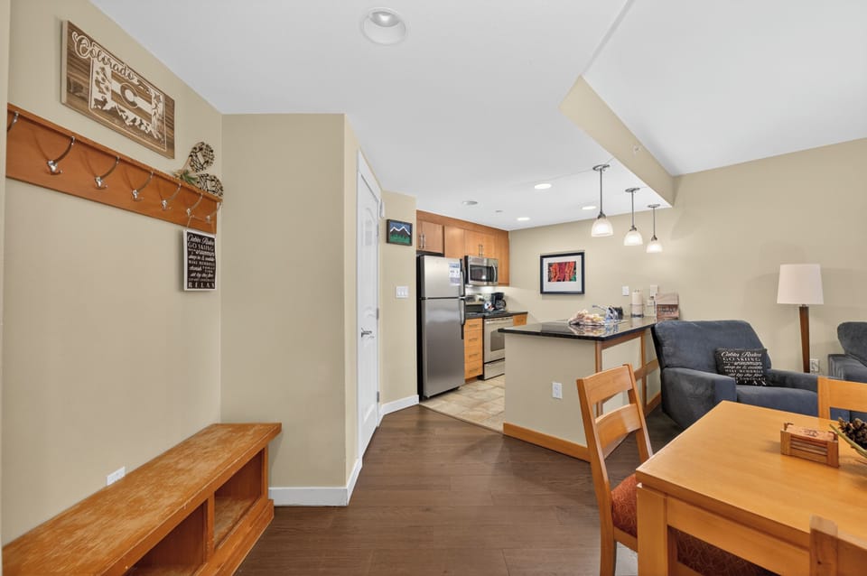 Your open-concept living space flows seamlessly from living room to kitchen, with natural light and warm wood accents inviting you to settle in and make yourself at home.
