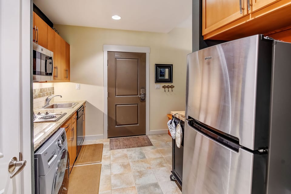 Your fully equipped kitchen features stainless steel appliances, warm wood cabinetry, and everything you need to prepare meals at your own pace during your stay.