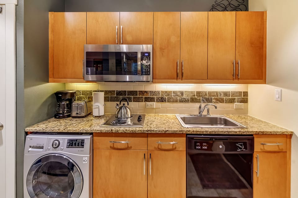 Your fully equipped kitchen makes self-catering easy, with granite counters, stainless appliances, and all the essentials—including a convenient in-unit washer for longer stays.