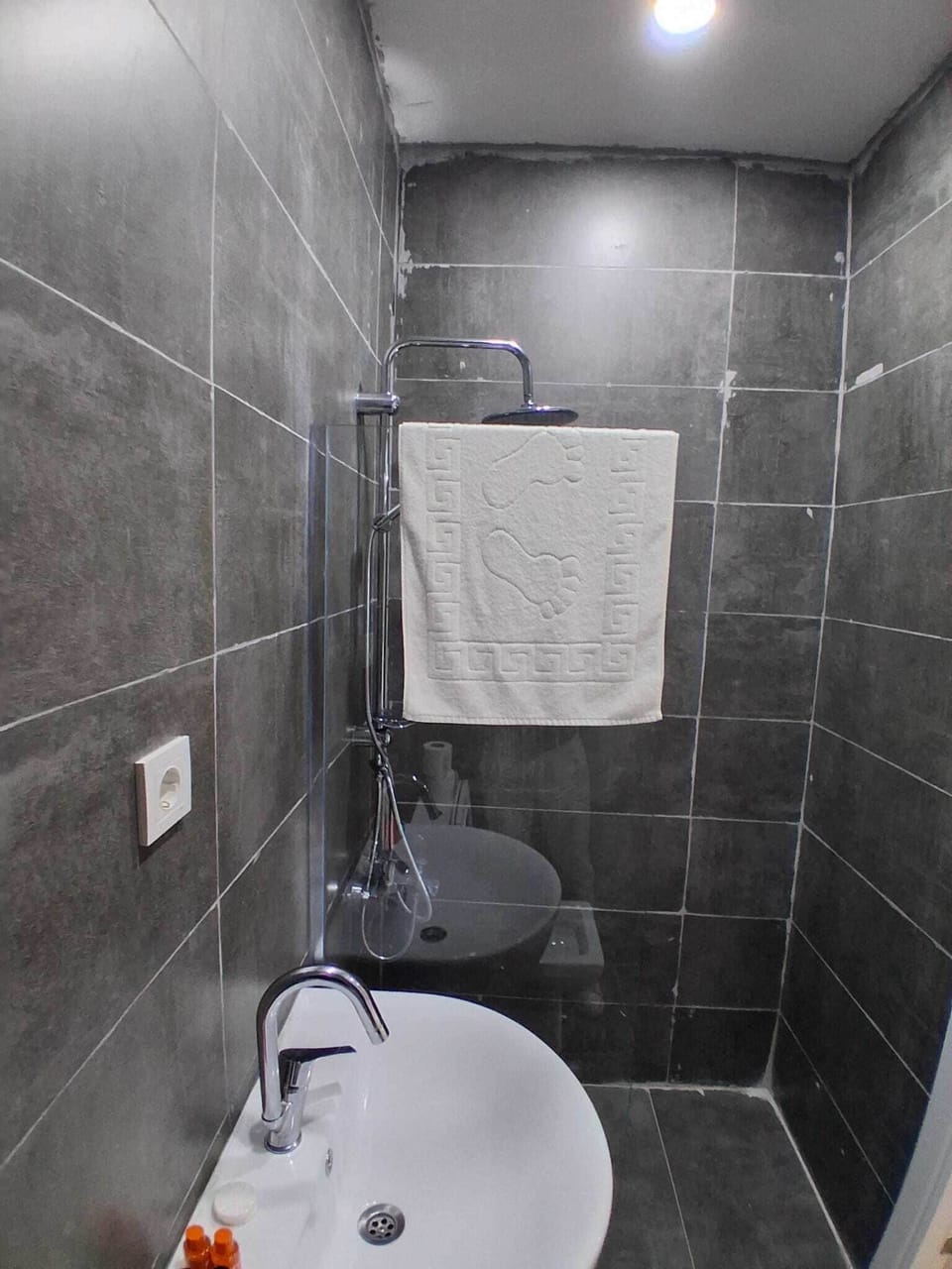 Shower, hair dryer, slippers, towels