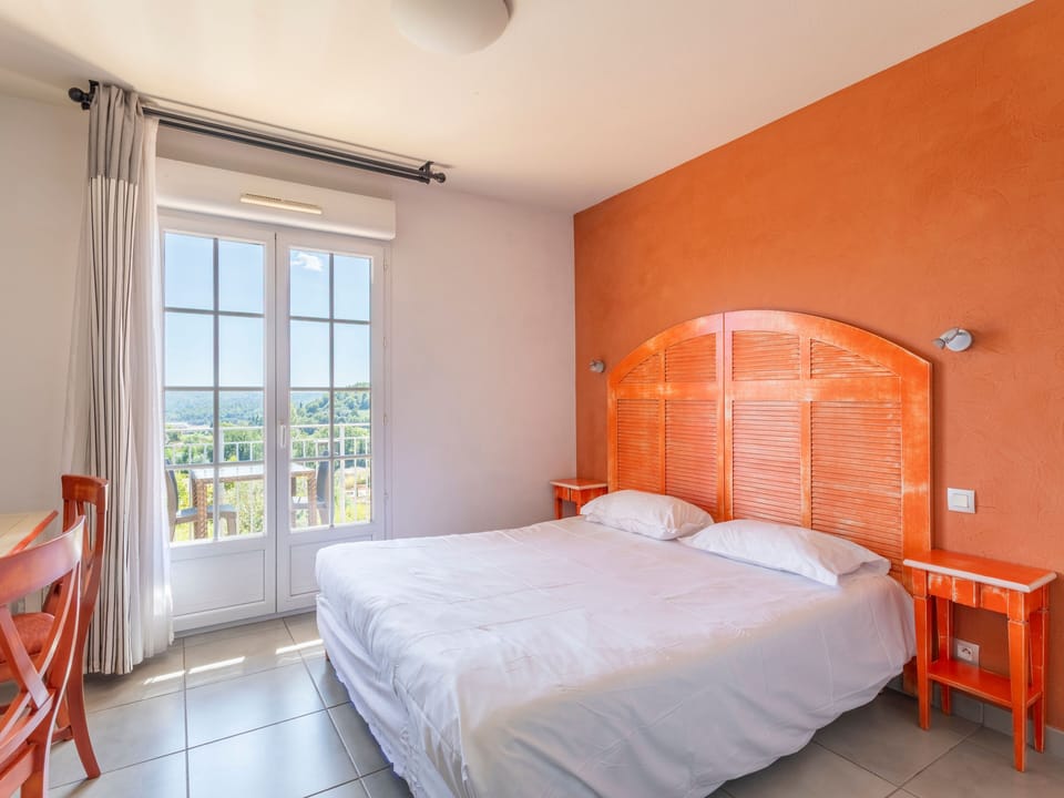 Private balcony off the double room with open views over the wooded hilltop — morning coffee territory