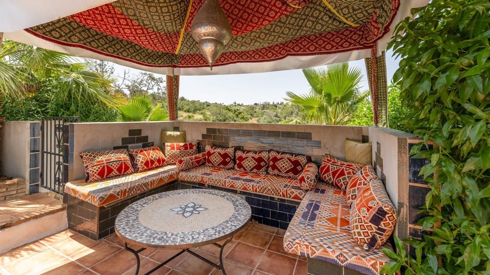 Shaded pergola lounge with Moroccan-inspired charm, perfect for slow mornings or golden-hour drinks. #Alcantarilha #AlgarveVilla #OutdoorLiving