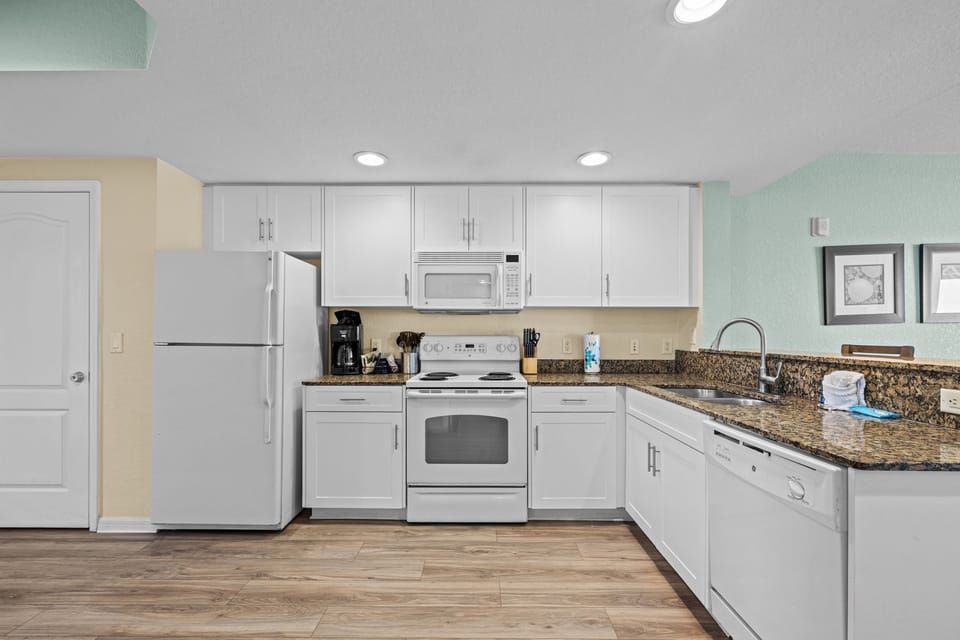 Cook up a storm in this modern kitchen, featuring sleek granite countertops and full-size appliances.