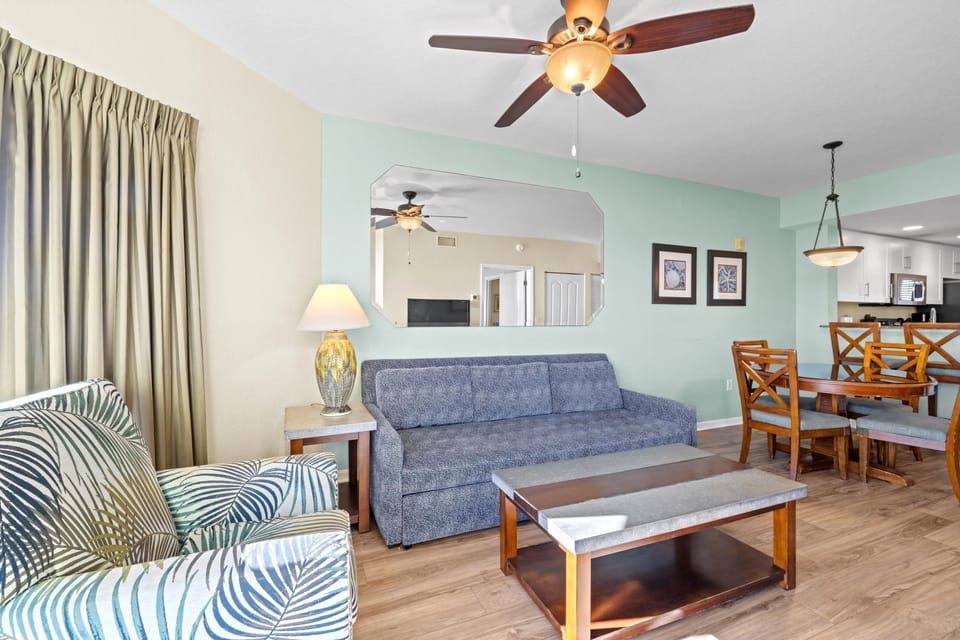 Unwind in the cozy living area, complete with inviting furniture and natural light filtering through the curtains.
