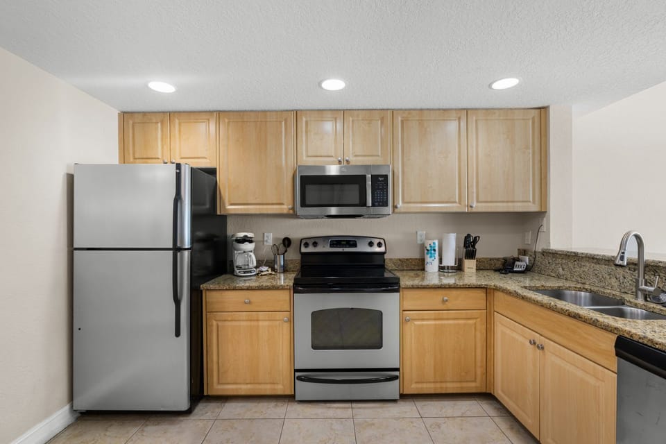 Enjoy a functional layout with sleek cabinetry and granite countertops in this inviting kitchen.