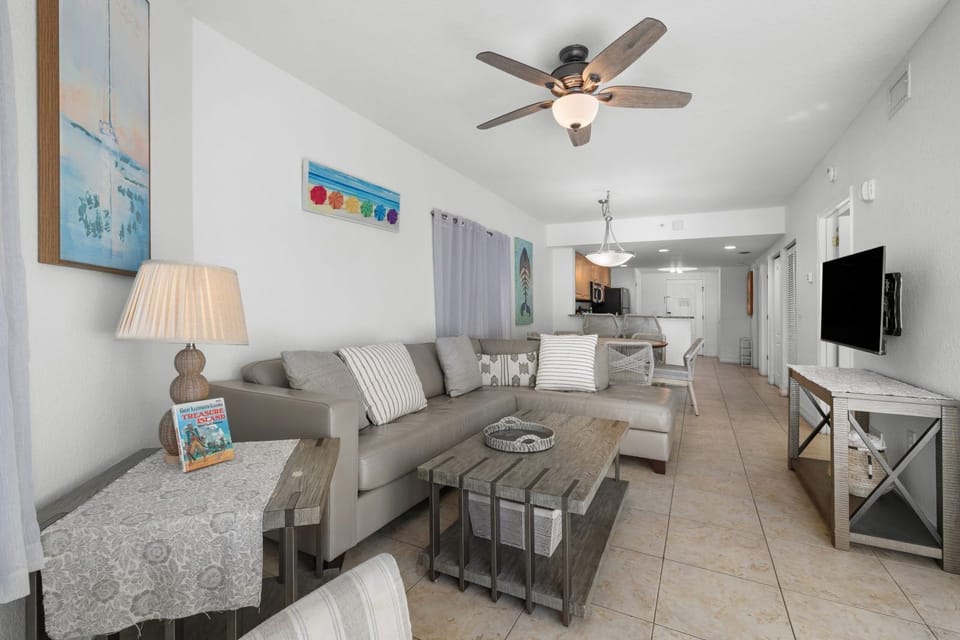 Unwind in the cozy living area, complete with comfortable seating and tasteful beach-inspired decor.