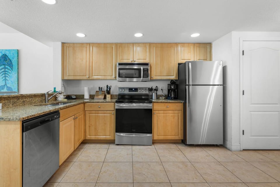Cook gourmet meals in a spacious kitchen with granite countertops and modern stainless steel appliances.