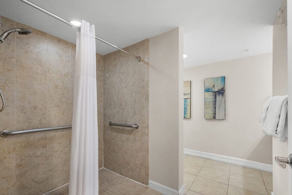 Roll-in shower with grab bars — thoughtfully designed for full accessibility and ease of use.