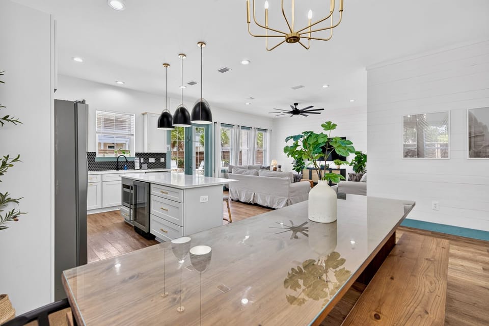 1st floor- Dining area with glass-top farmhouse table and bench seating—seats the whole group comfortably and sits right off the kitchen for easy flow between cooking and eating