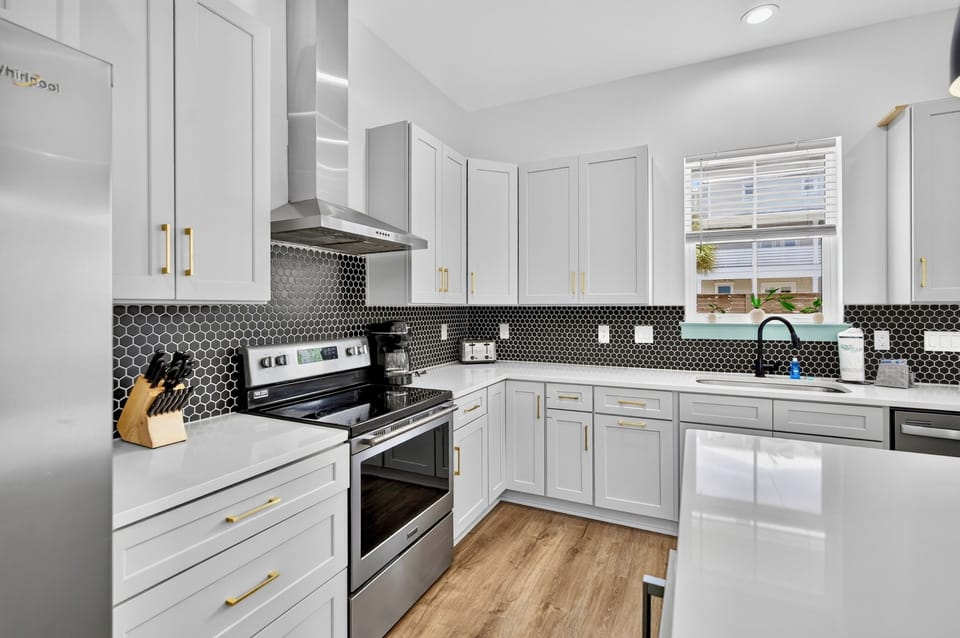 1st floor- Kitchen with electric range, shaker cabinets, and plenty of counter space—everything you need to cook for a large group 