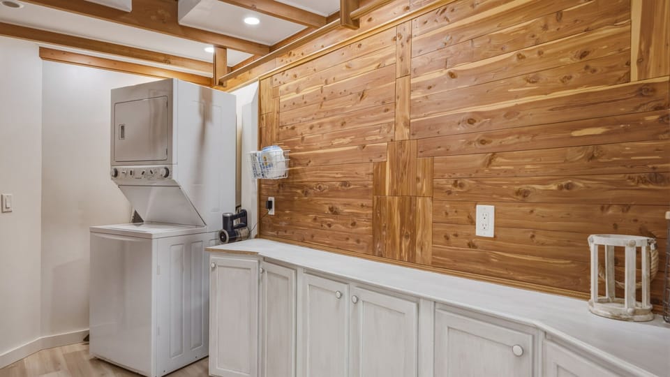 Convenient laundry room equipped with a washer and dryer, making it easy for guests to freshen up clothes during their stay. A practical space designed for longer visits, outdoor adventures, or keeping up with family travel