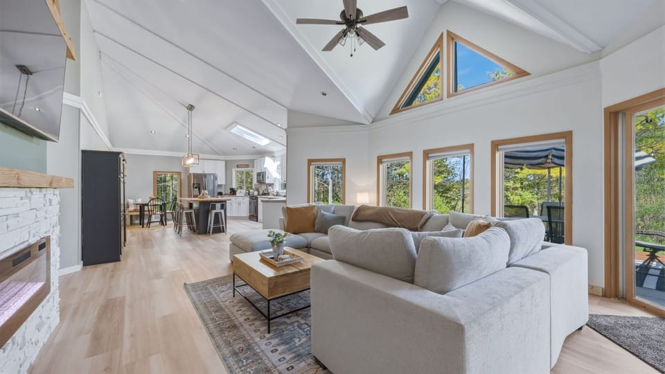 Bright open-concept living, dining, and kitchen area designed for easy gathering and connection.