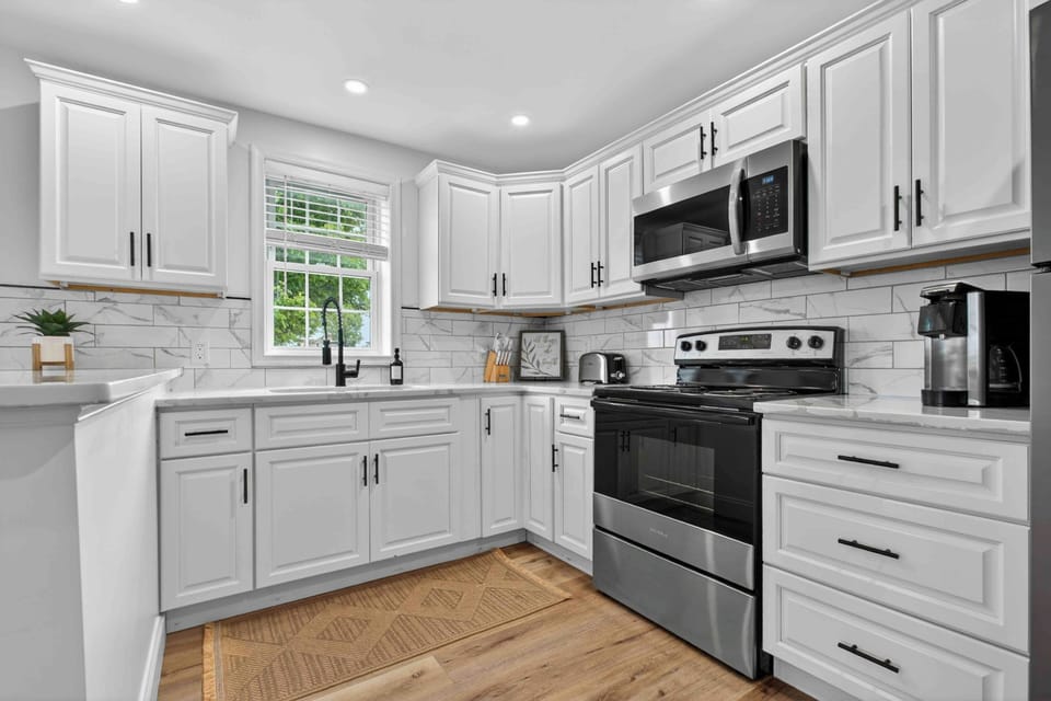 Bright chef’s kitchen with stainless appliances and coffee bar