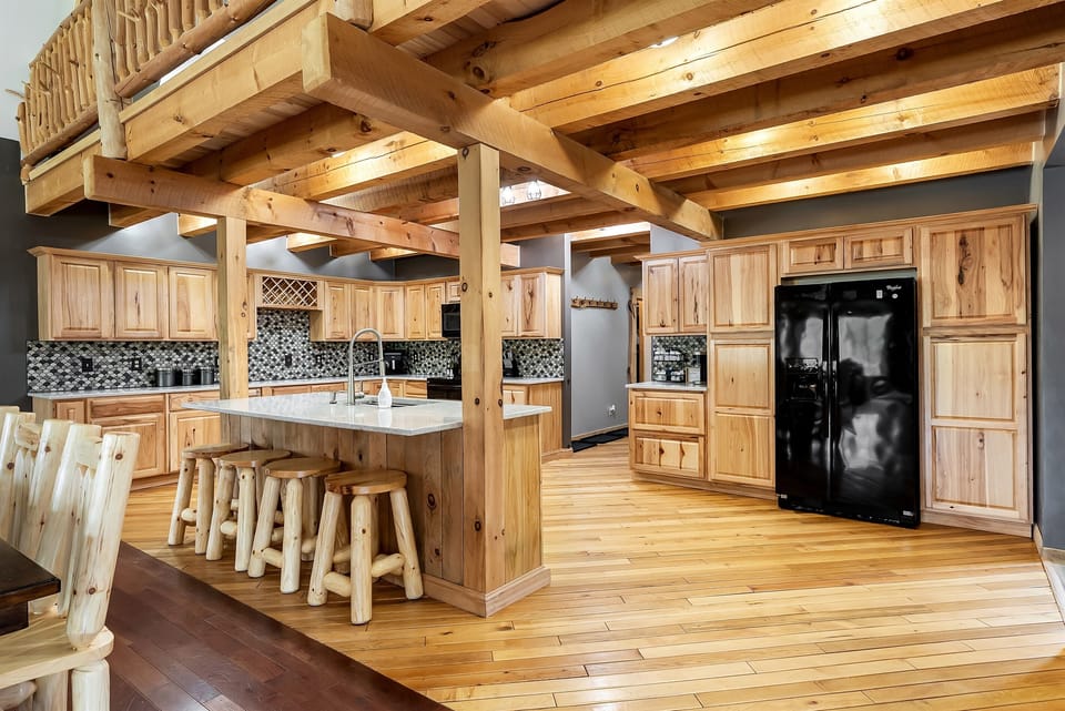 Huge Kitchen with island, dishwasher, stove, refrigerator, microwave, air fryer, cooking utensils and Keurig.