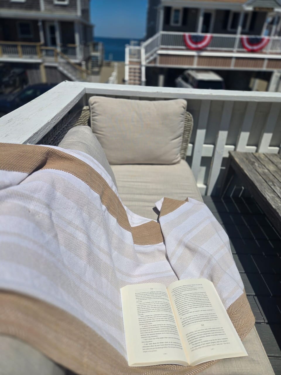 Cozy balcony lounge with ocean glimpse—perfect for a relaxing coastal stay